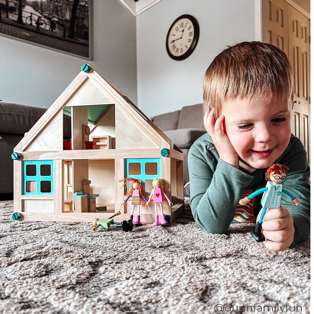 A boy playing with Dollhouse