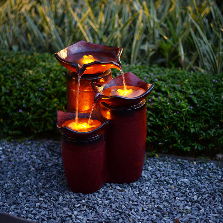 daytime image of the red fountain in a garden