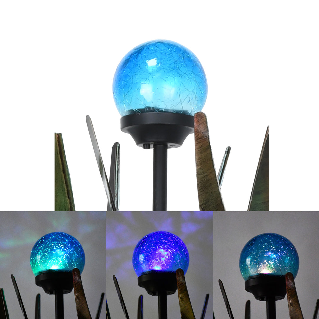 Close-ups of the solar powered light on the tulip-shaped wind spinner