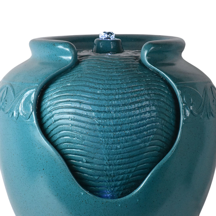 A teal vase-shaped water fountain