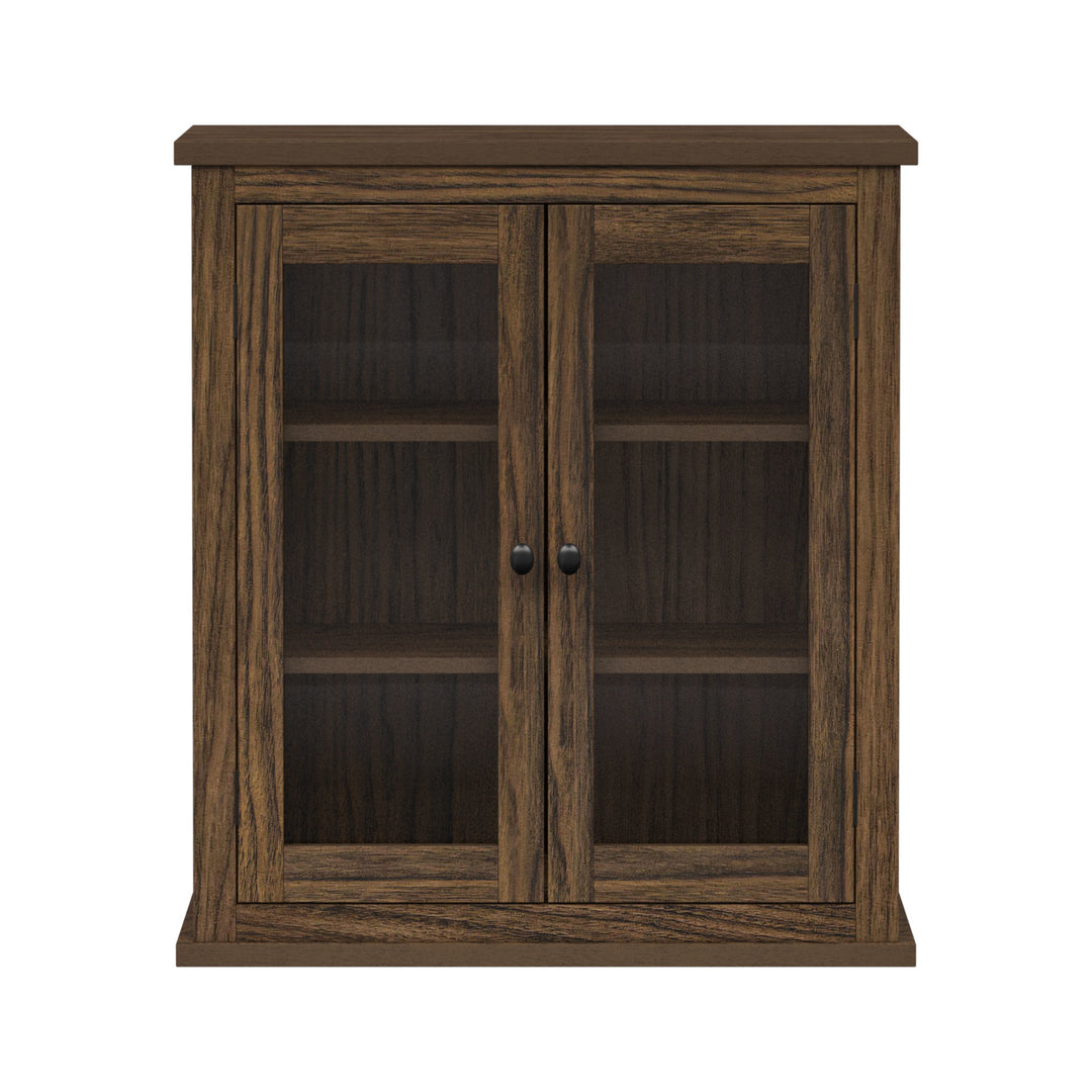 Walnut-finished wall cabinet with two glass doors.