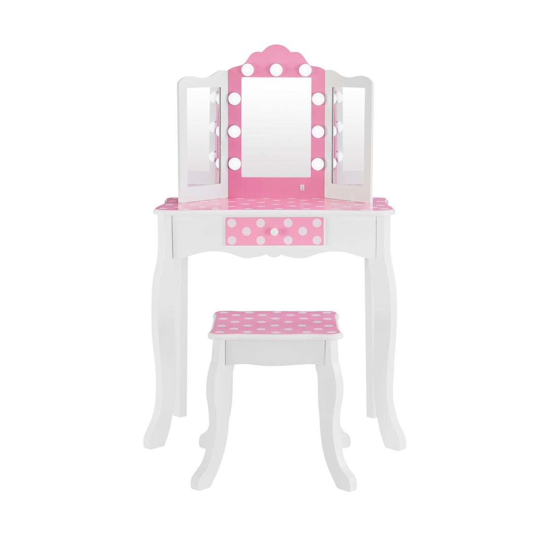 A white child's vanity set with pink and white polka-dotted accents with lights around the center mirror