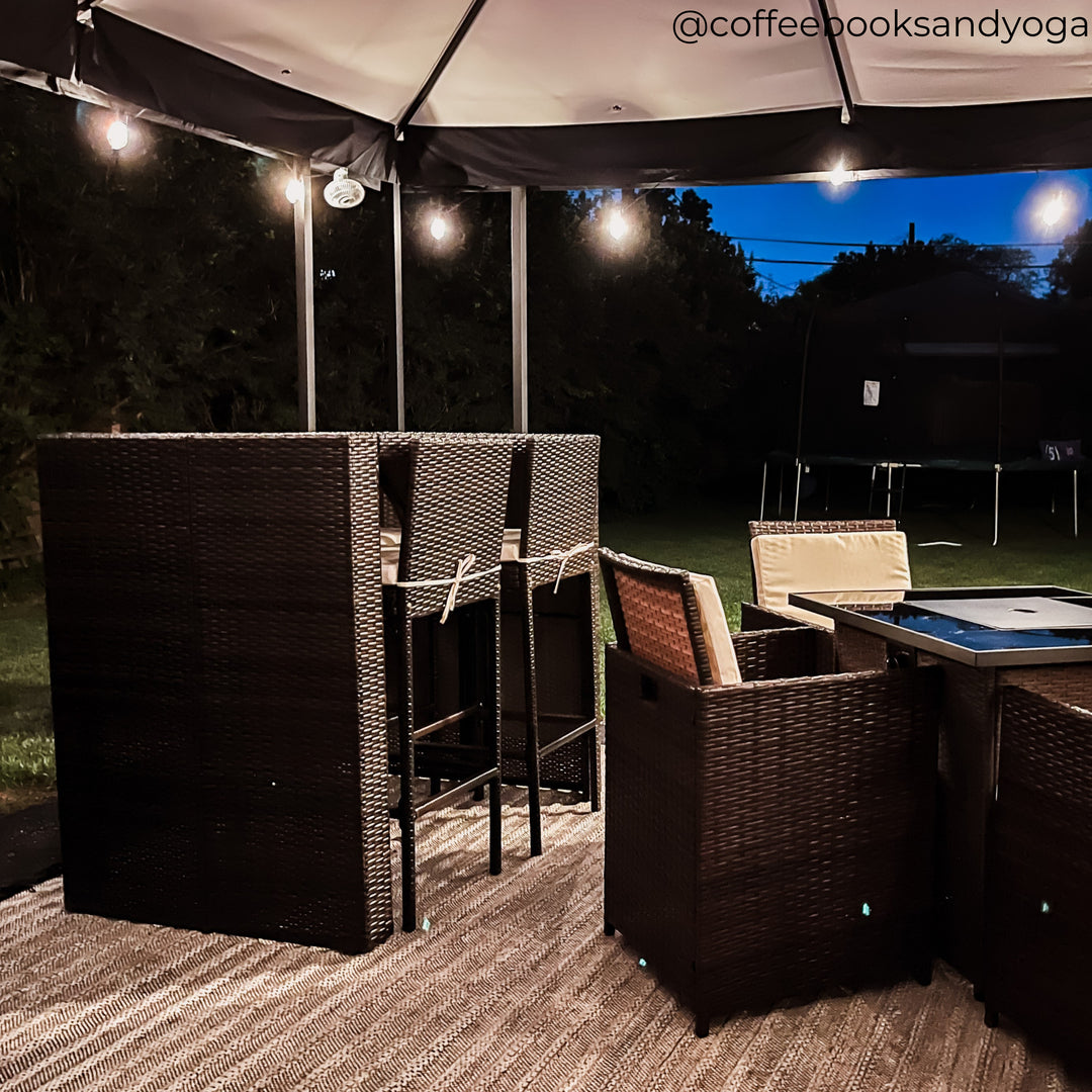 A patio at night with a 5-iece dining set 