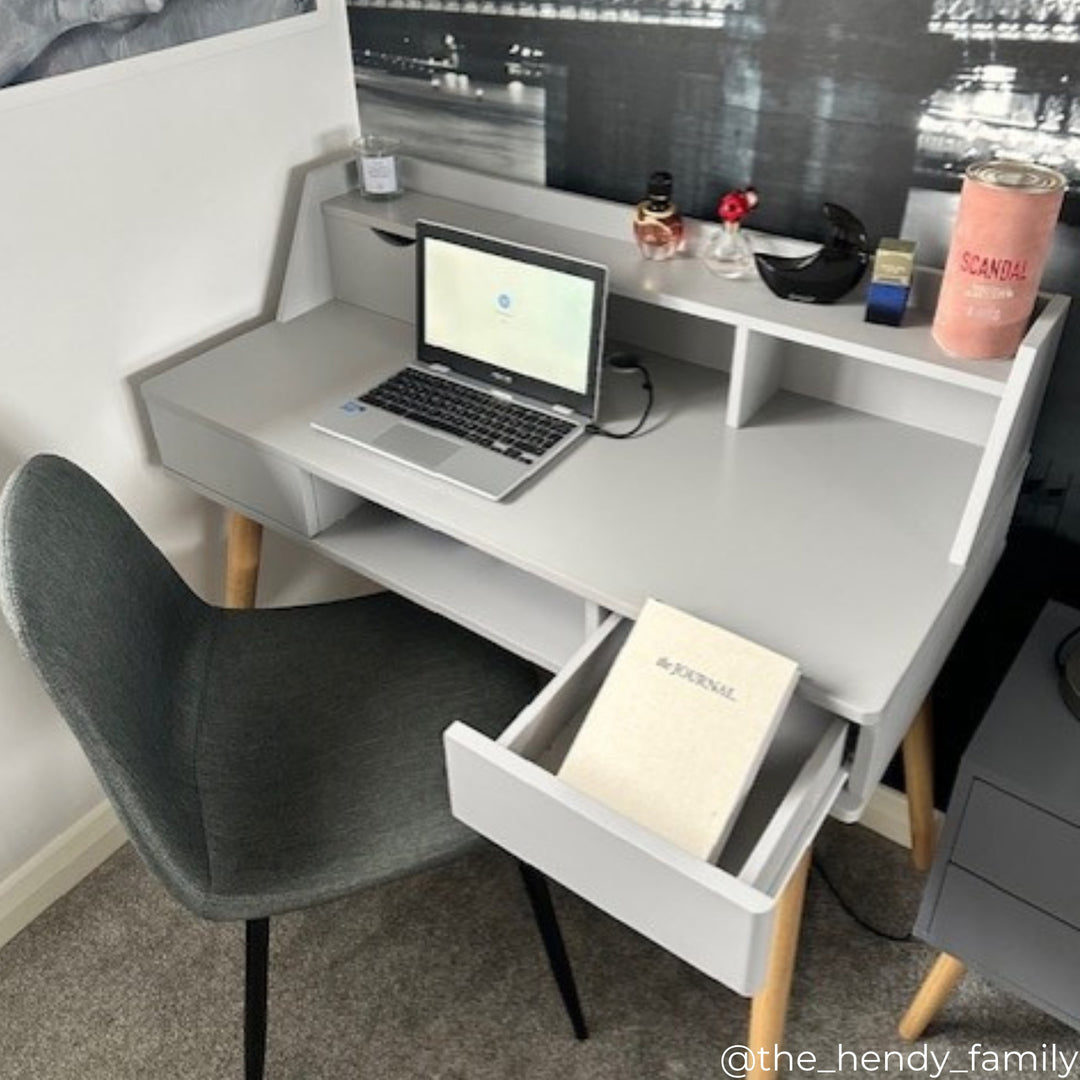 Influencer image of creativo desk in gray with a gray desk chair in an office space.