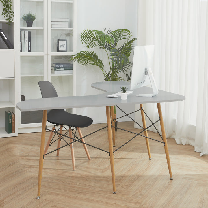 A home office with a bookshelf, l-shaped desk and black chair