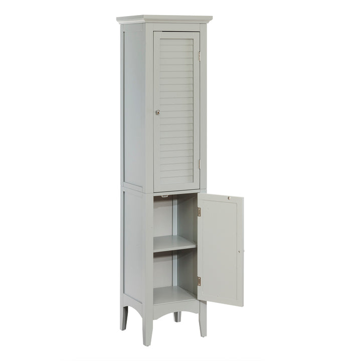 A tall gray linen cabinet with faux louvered doors with the bottom door opened