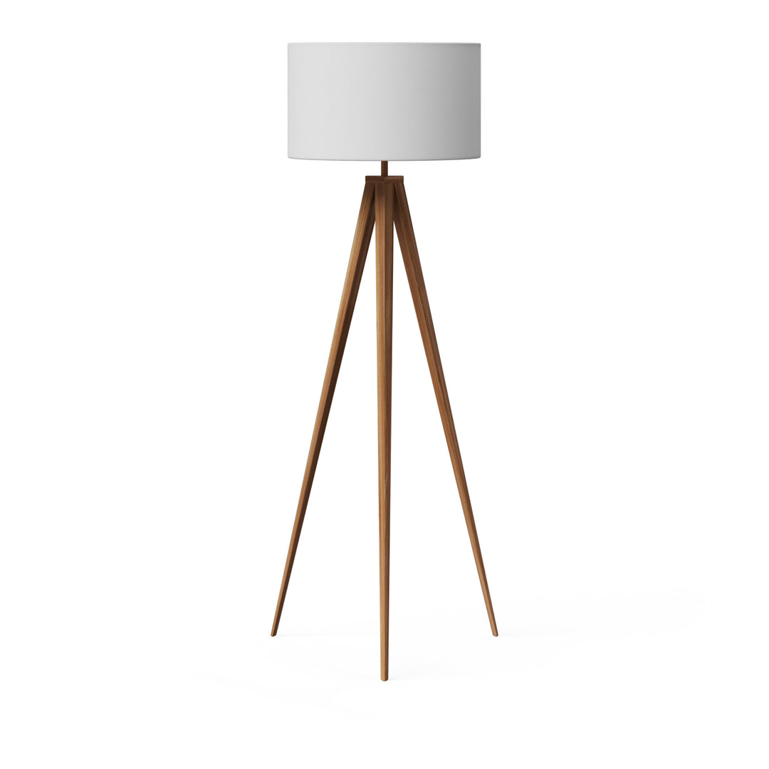 A tripod style floor lamp with natural wood finished legs and a white faux linen lampshade