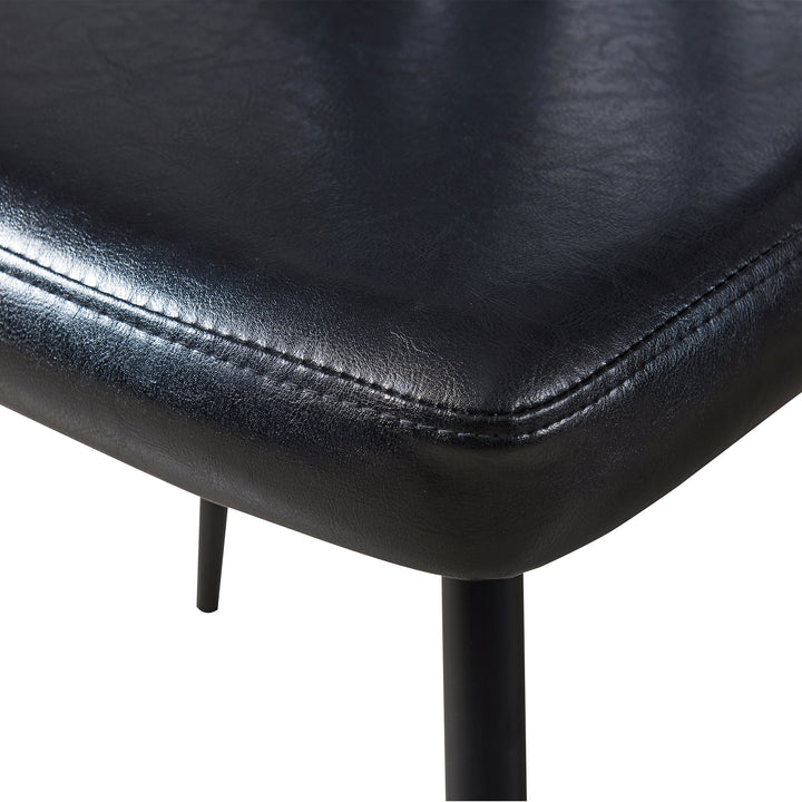 Detailed image of the stitching and material of the black chair.