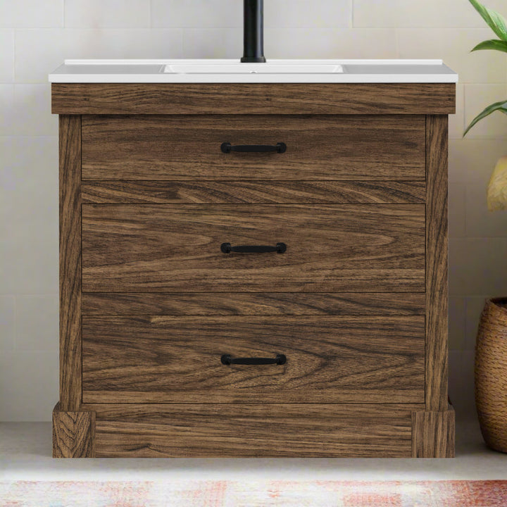 Walnut finished sink vanity with black hardware and white ceramic countertop and sink against an ivory wall.