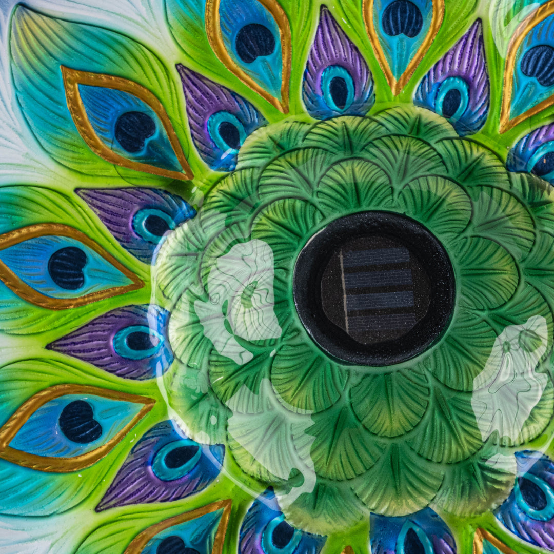 Closeup of the solar panel at the center of the green, blue, and purple fused glass bowl.