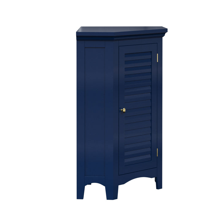 A navy blue corner floor cabinet with gold knobs and two faux louvered doors from the side.