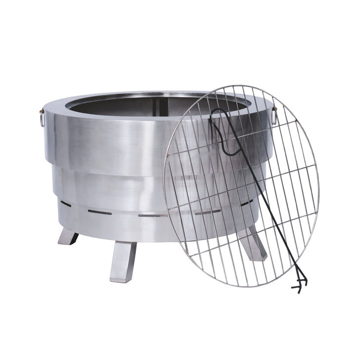 A round stainless steel fire pit with a removable grill grate and a hook. The fire pit stands on four sturdy legs.
