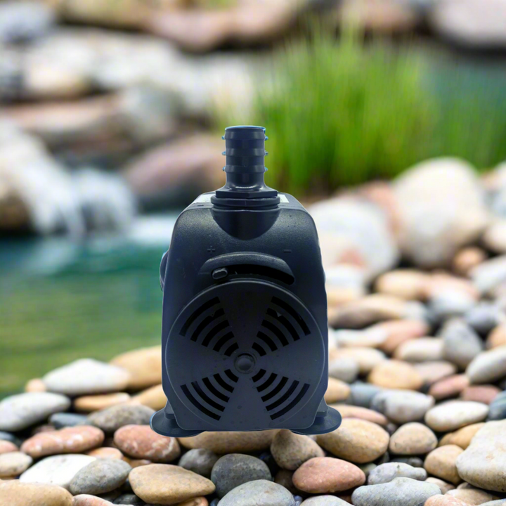 pump shown on rocks next to a small pond