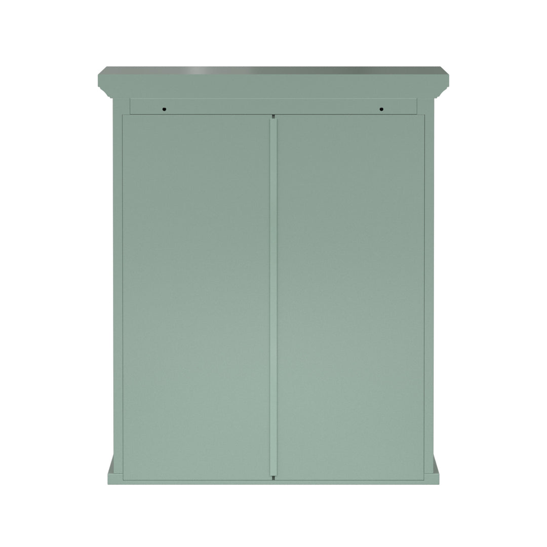 Back view of a sage green wall cabinet with chrome knobs and two faux louvered doors.