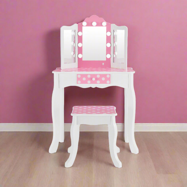 pink polka dot vanity with LED lights on, in a pink room