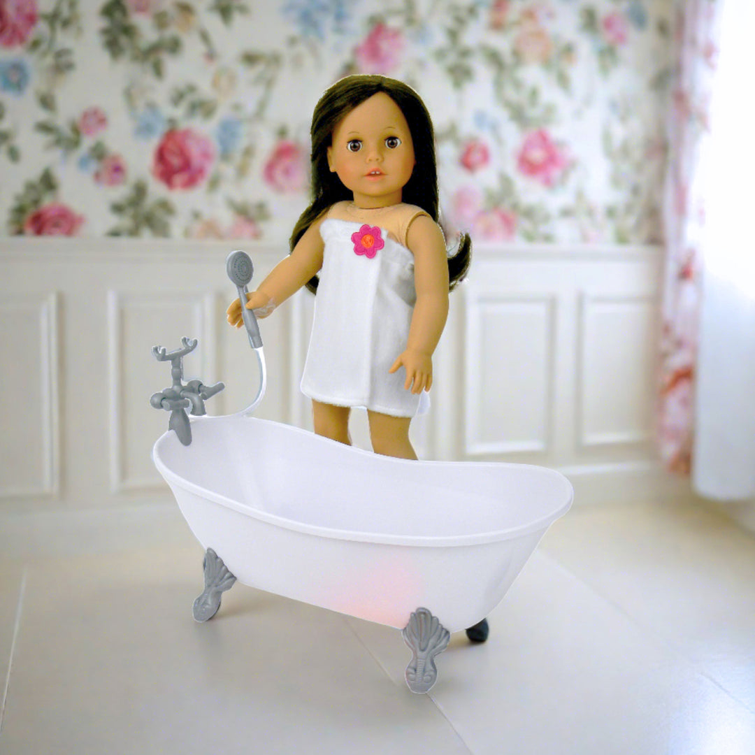 a brunette doll holds the showerhead in a floral bathroom