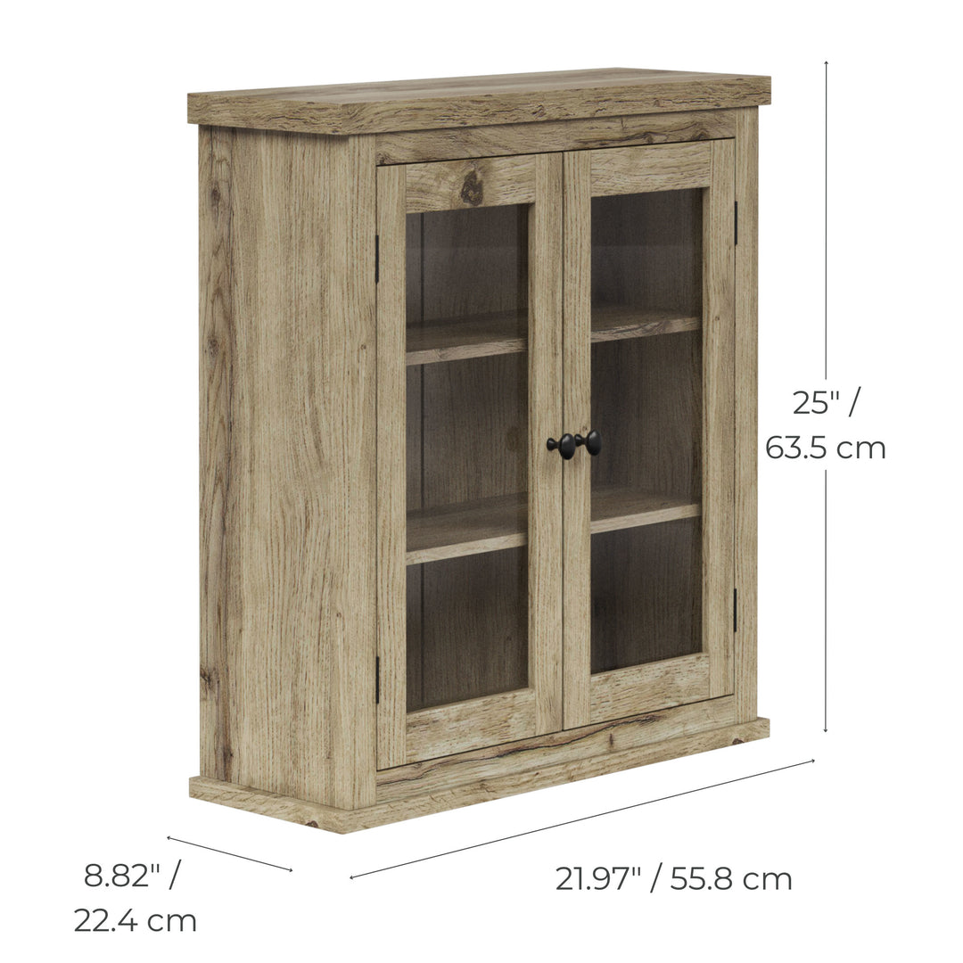 Dimensional graphic of a light oak finished two-door wall cabinet with glass panels