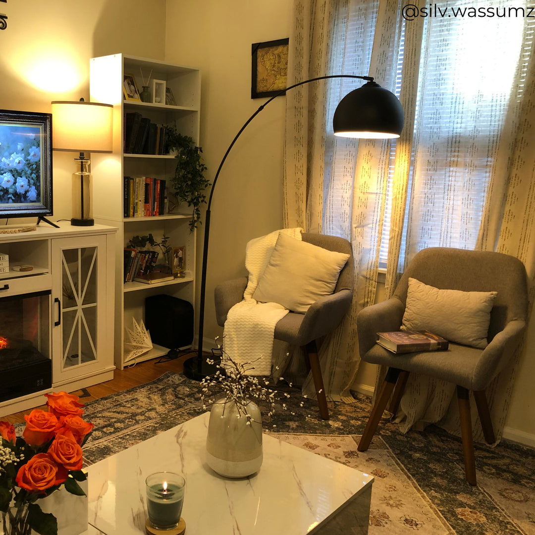 A black arc lamp in a cozy living room