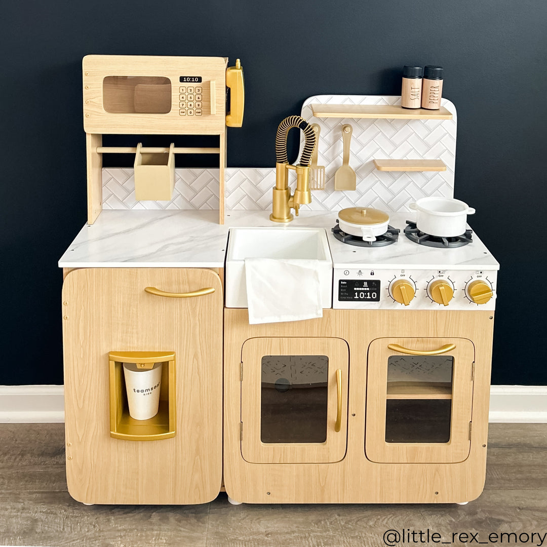 A play kitchen with faux white marble counter tops and wood finish