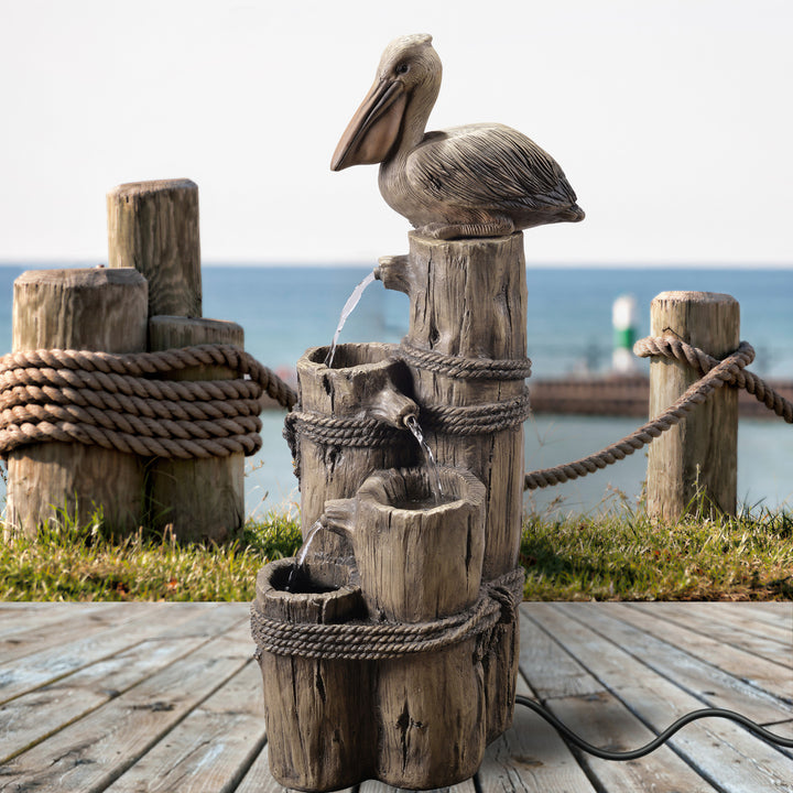 Pelican driftwood fountain at a dock