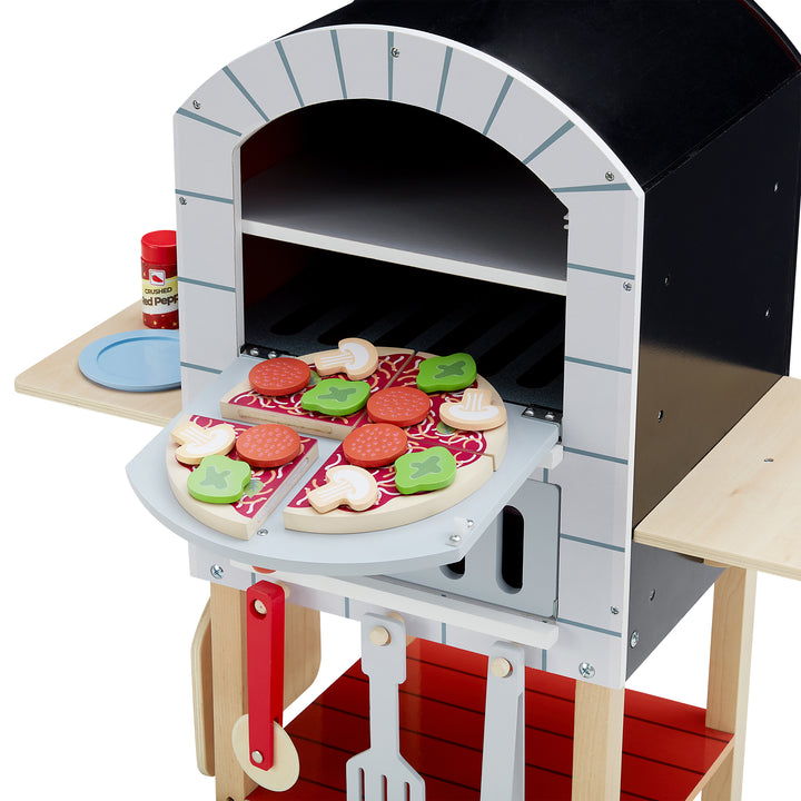 Close-up of pizza oven and pretend pizza