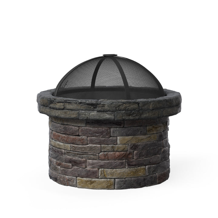 A round faux brick wood burning fire pit with a spark screen