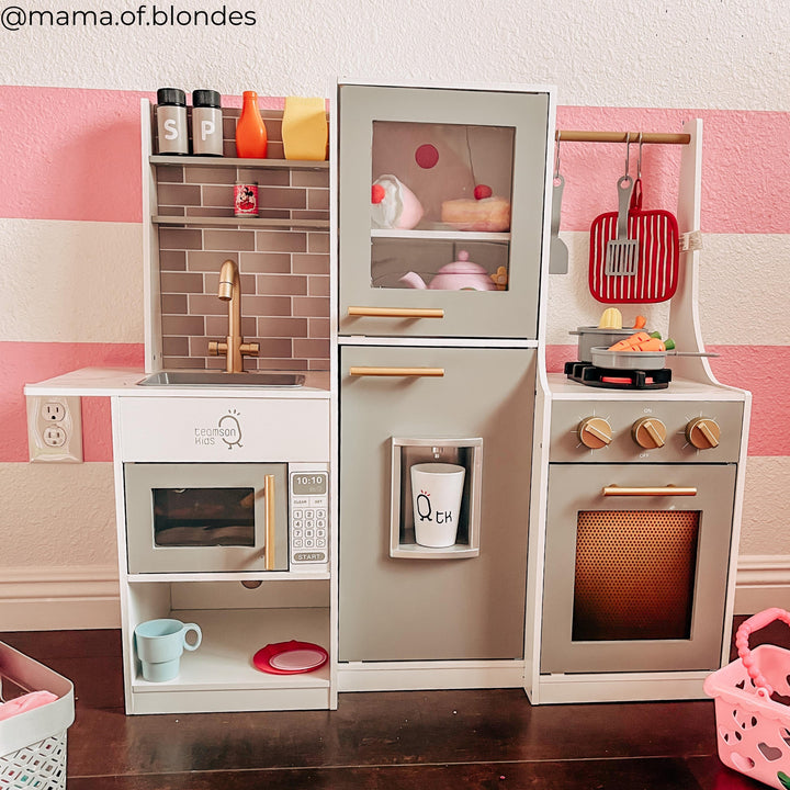 A picture of a play kitchen in a colorful playroom