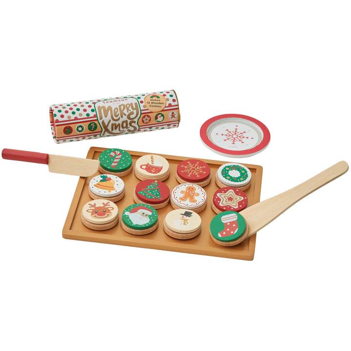 A tray with pretend christmas cookies, a spatula, a knife, a plate and a roll of dough