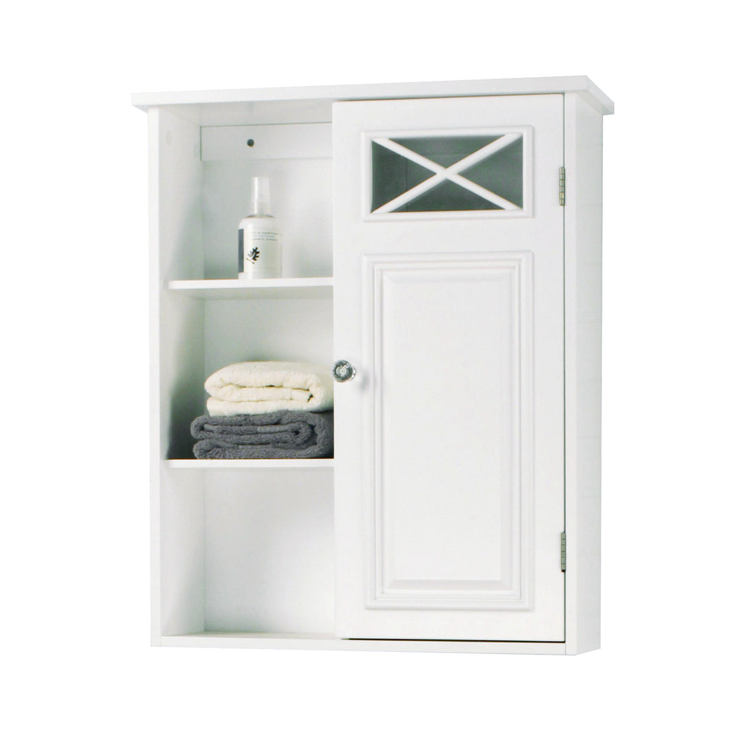 A white wall cabinet with three open shelves with towels and lotion stored on them