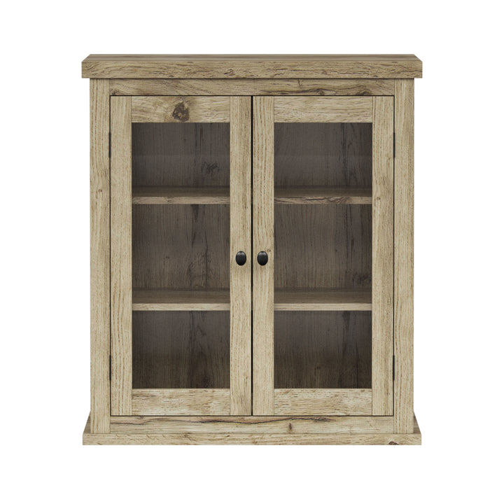 Light oak finished two-door wall cabinet with glass panels.