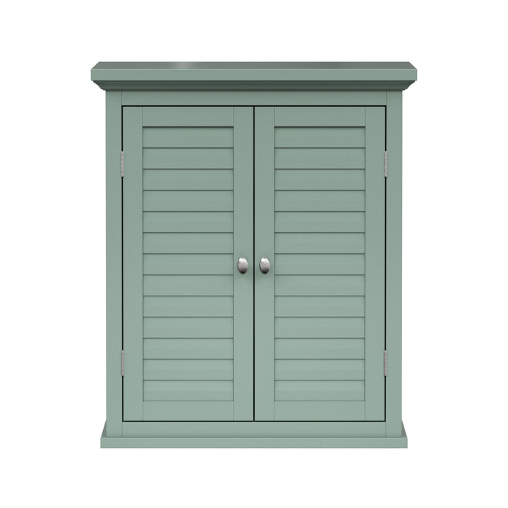 Sage green wall cabinet with chrome knobs and two faux louvered doors.