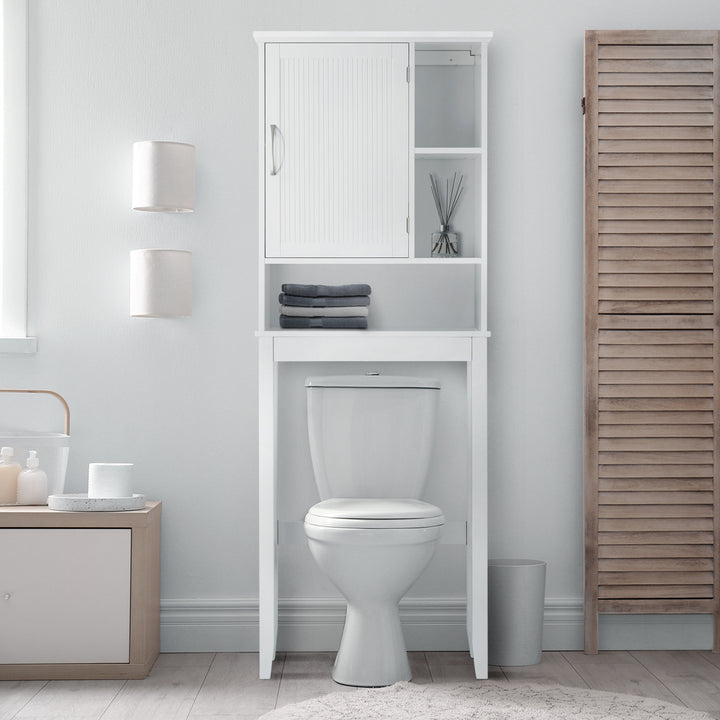 Lifestyle image of the over the toilet cabinet in a white bathroom, towels on the lower open shelf. 