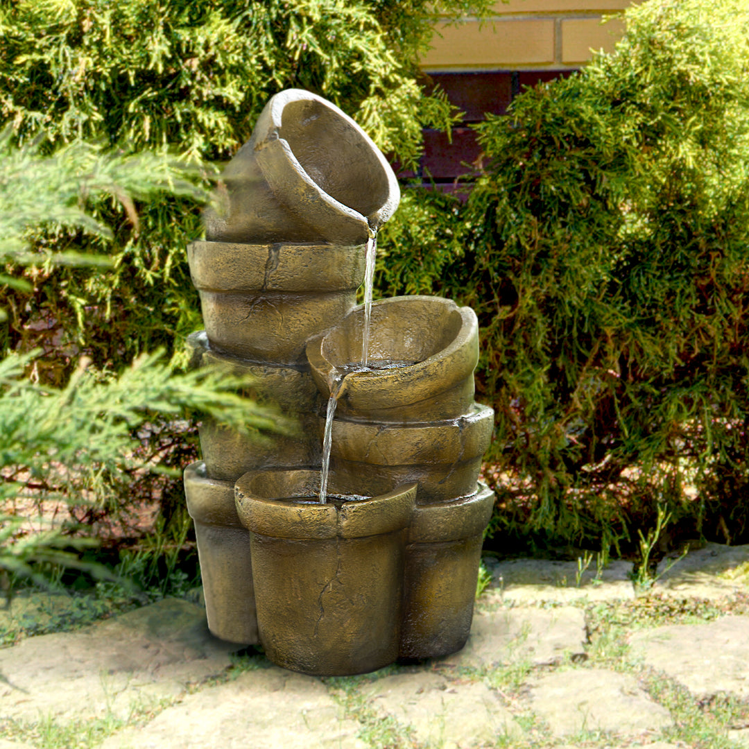 Pots fountain in an overgrown garden