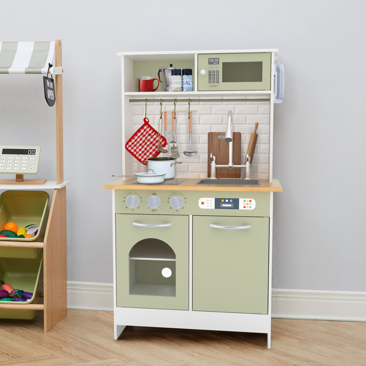 A kids play kitchen with a pretend market stand next to it