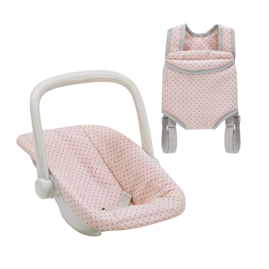 A child's pretend infant car seat and harness in pink with gray polka dots