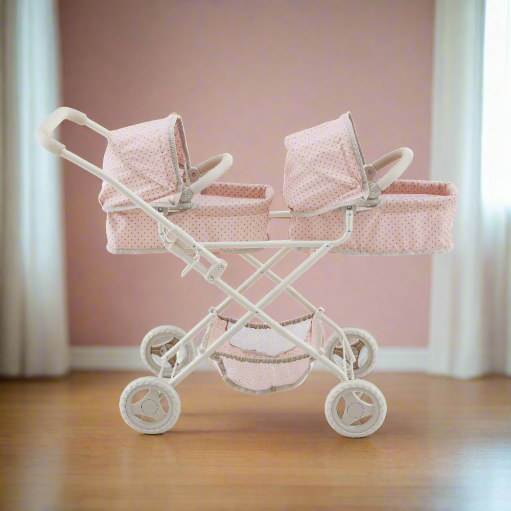 A pink and gray double bassinet stroller sits in a neutral colored play room