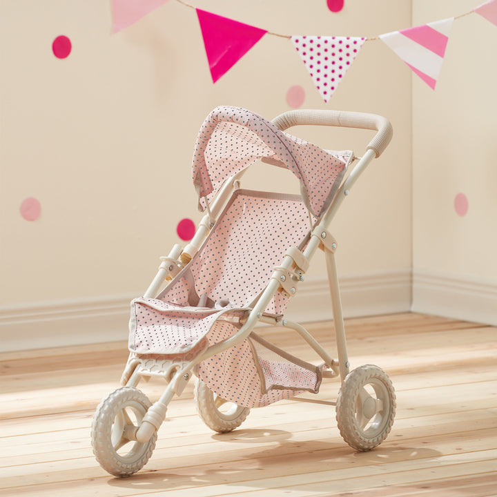 A pink with gray polka dots child's play jogging style stroller