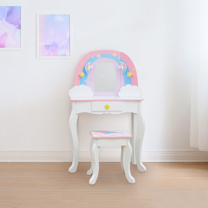 A white vanity table and stool with a rainbow, unicorns, stars, and a mirror.