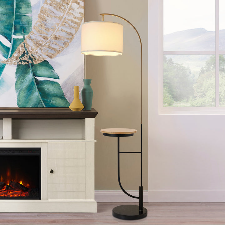 A Teamson Home Danna Floor Lamp with Marble Base and Built-In Table, White next to a fireplace