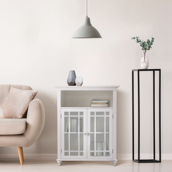 A Teamson Home Craftsman Style Double Door Storage Floor Cabinet in a room with a couch and a lamp.