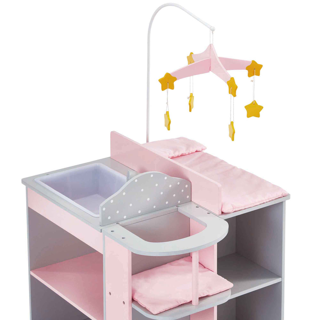 A baby doll changing station in pink and gray with white polka dots with a closet, storage shelves, high chair, mobile, sink, and changing table.