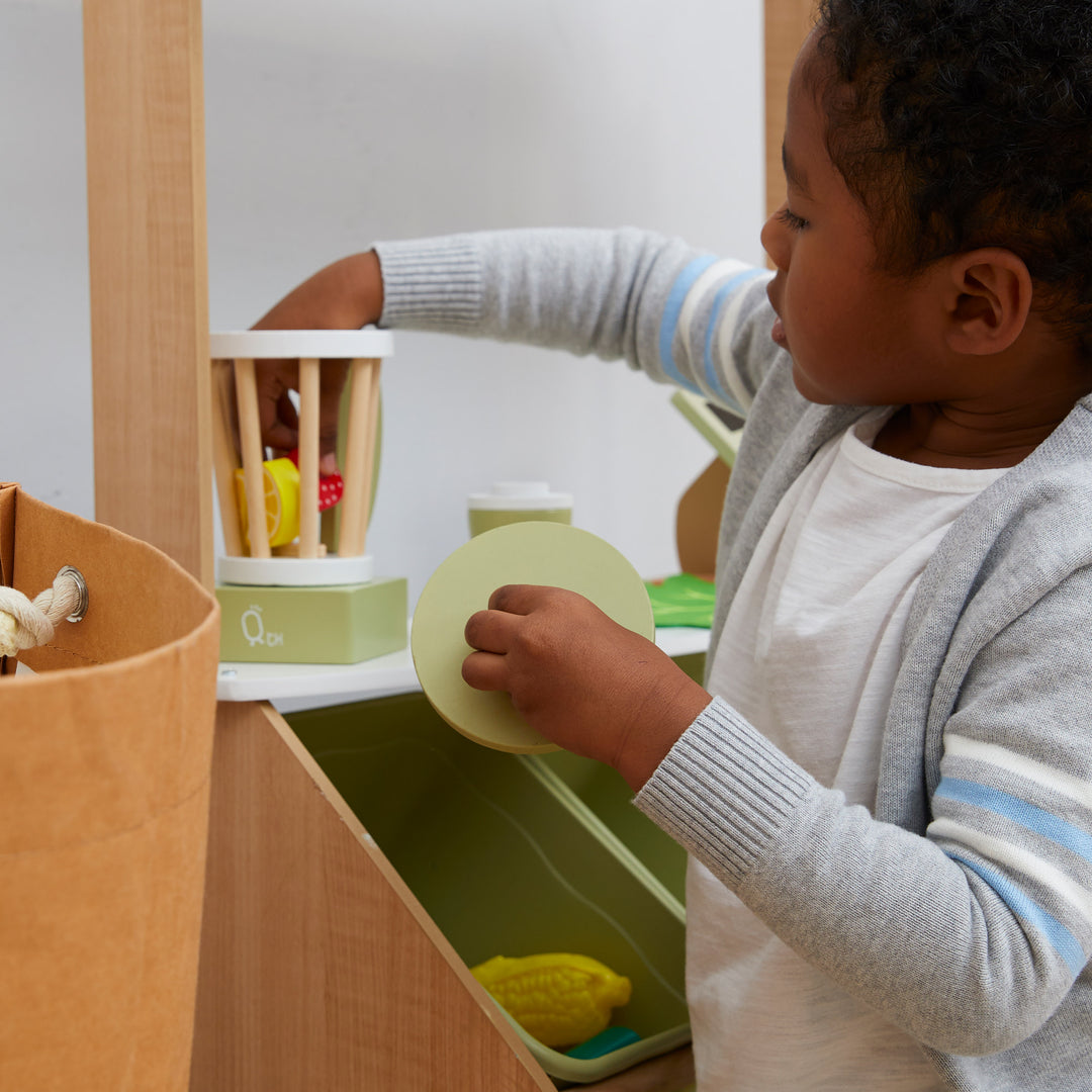 Child playing with Teamson Kids Little Chef Frankfurt Wooden Blender Play Kitchen Accessories, Green.