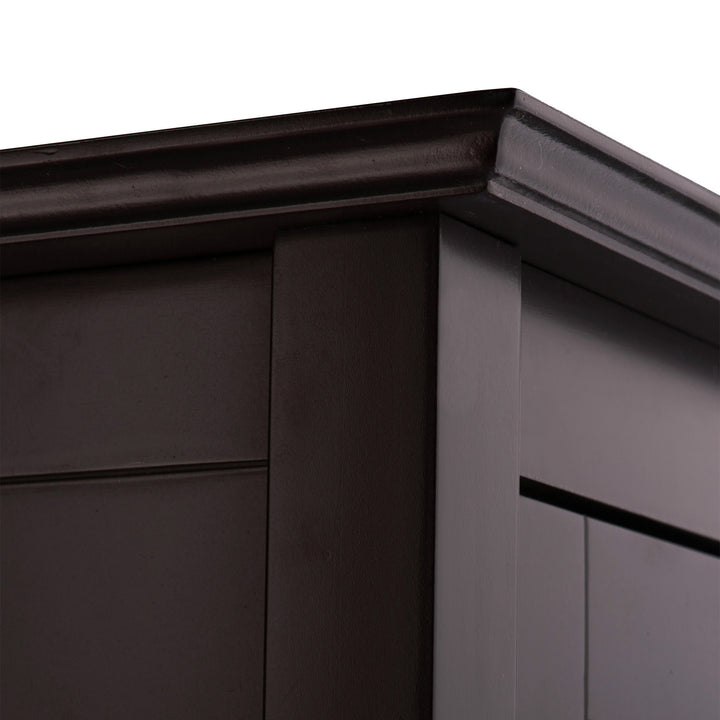 A close up the crown molding on the Teamson Home Chesterfield Wooden Floor Cabinet with Storage Drawer and Waffle Glass Door, Espresso