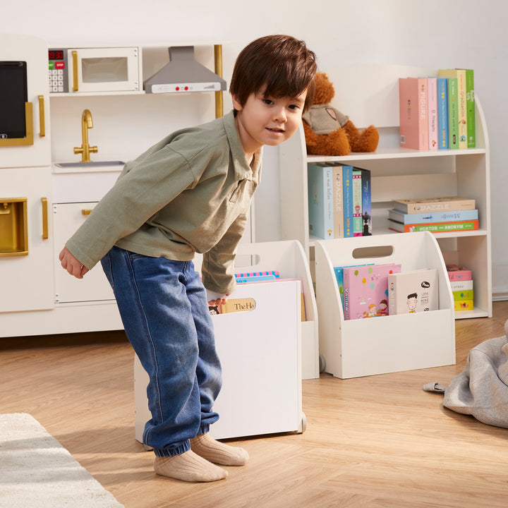 A little boy pulling a portable bookcase by the handle as it glides on the wheels.