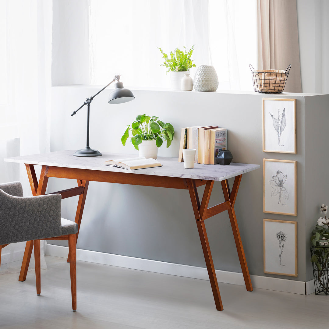 A durable Teamson Home Ashton Rectangular Marble-Look Dining Table with Wood Base, Marble/Walnut in a room with a chair and a plant.