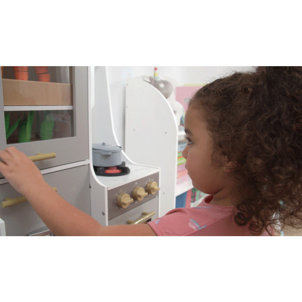 Child looking into the hydroponic garden door of the Little Chef Lyon Play Kitchen.