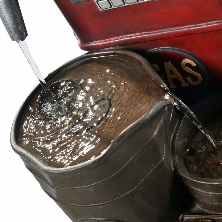 A view of the tallest tier underneath the gas pump nozzle, where the water originates from