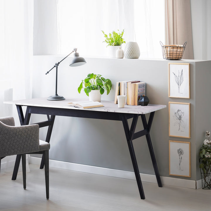 Teamson Home Ashton Dining Table with Black Wood Base and Faux Marble Tabletop with a desk lamp, potted plant, and books 