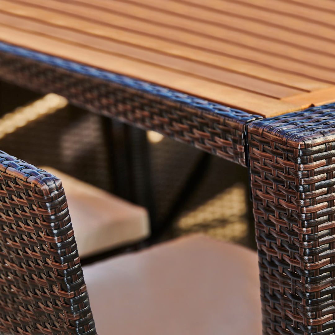 Close-up of a Teamson Home 5 Pc Outdoor Wicker Dining Set with Acacia Tabletop and Cushions, Brown.