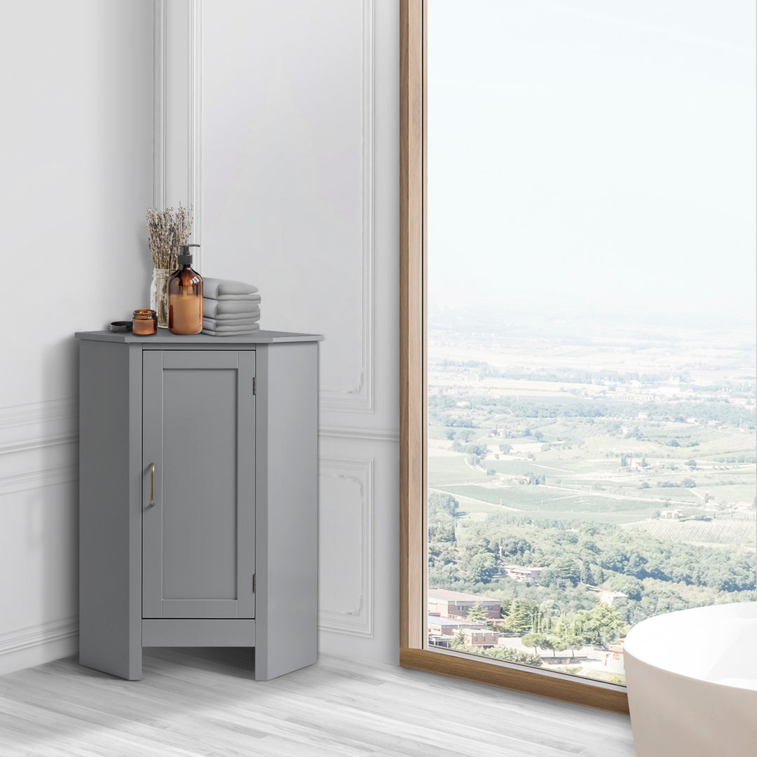 A Teamson Home Mercer Mid Century Modern Gray Corner Floor Storage Cabinet next to a window in a white room